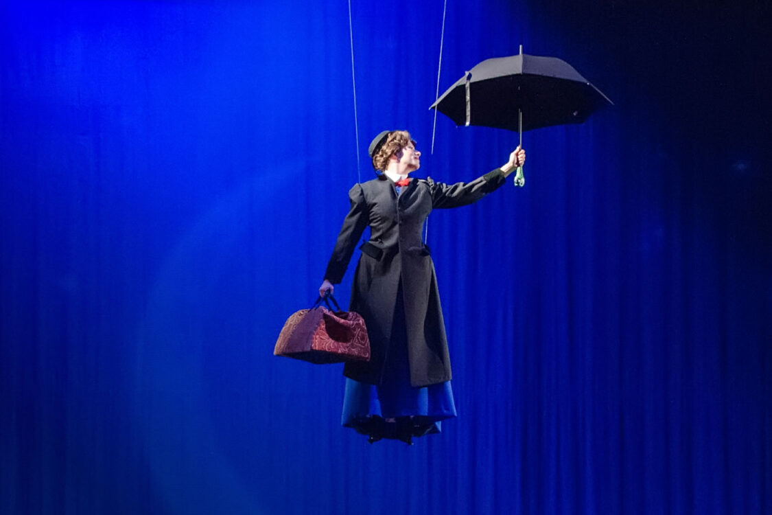 Mary Poppins flying on the stage