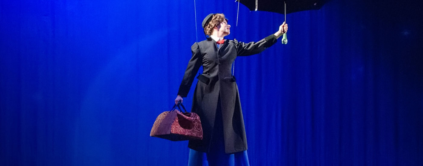 Mary Poppins flying on the stage