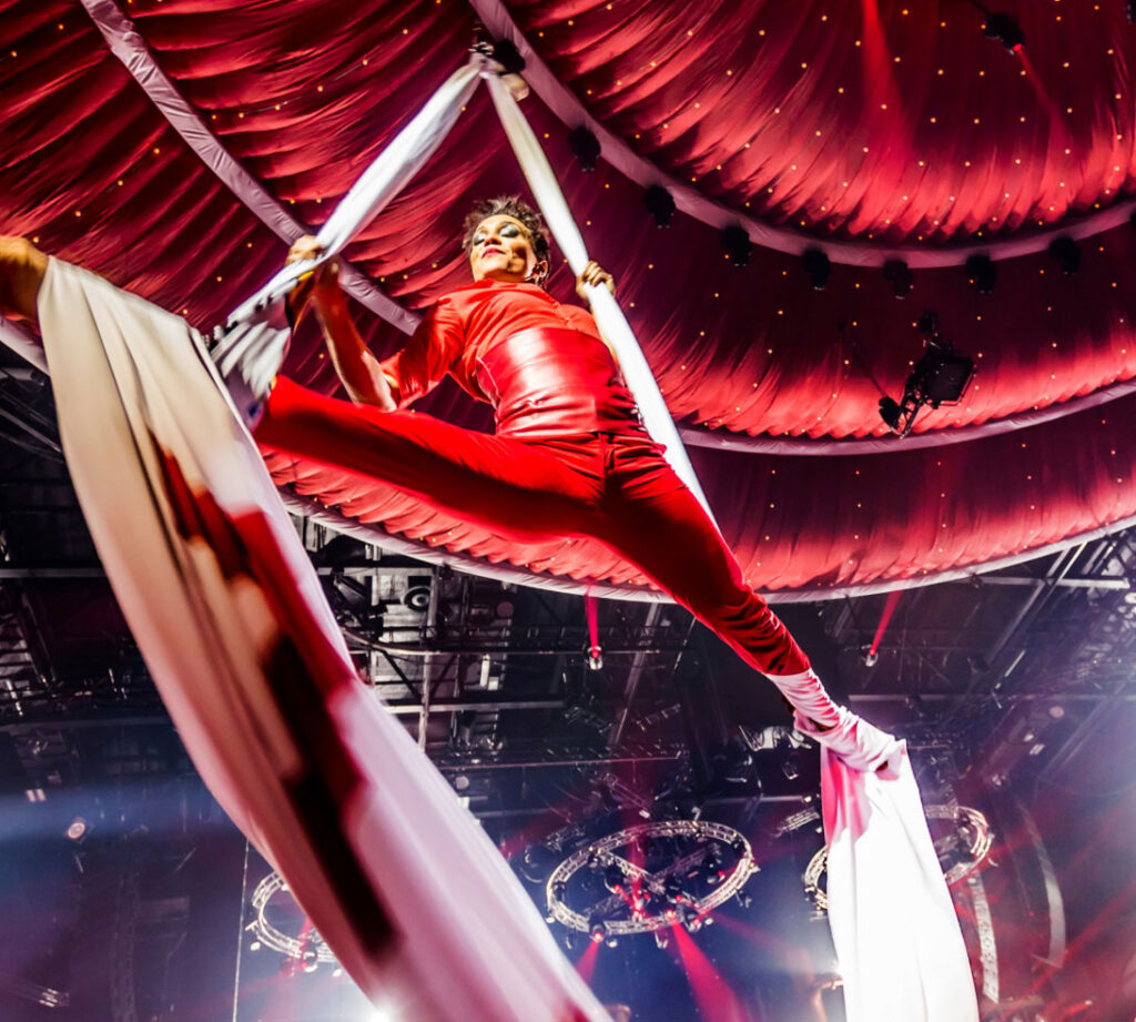 Aerialist in flight on stage